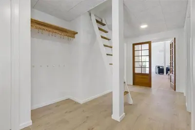 a hallway with white walls and stairs in a house at BL1358-Saltum-Solmarken-5 in Saltum