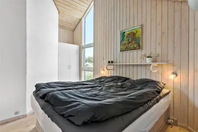 a large bed in a room with a window at BL247-Saltum-Haresvinget-9 in Saltum