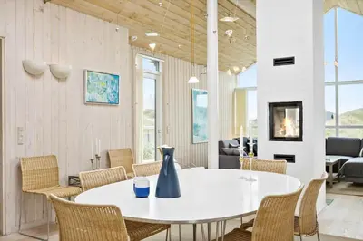 a dining room with a white table and chairs at BL247-Saltum-Haresvinget-9 in Saltum