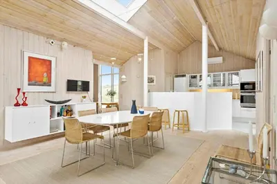 a kitchen and dining room with a table and chairs at BL247-Saltum-Haresvinget-9 in Saltum