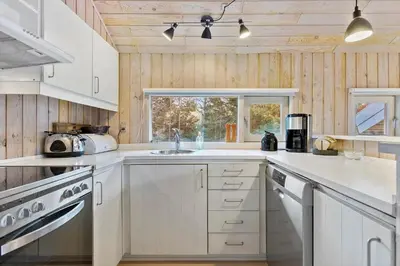a white kitchen with a sink and a window at BL224-Pandrup-Rodhusparken-91 in Pandrup