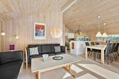 a living room with a couch and a table at BL224-Pandrup-Rodhusparken-91 in Pandrup