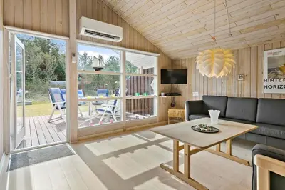 a living room with a couch and a table at BL224-Pandrup-Rodhusparken-91 in Pandrup