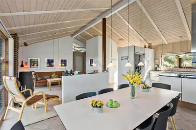 a kitchen and dining room with a table and chairs at BL852-Saltum-Revlingevej-14 in Saltum