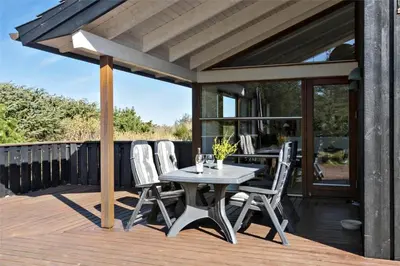a patio with a table and chairs on a deck at BL852-Saltum-Revlingevej-14 in Saltum