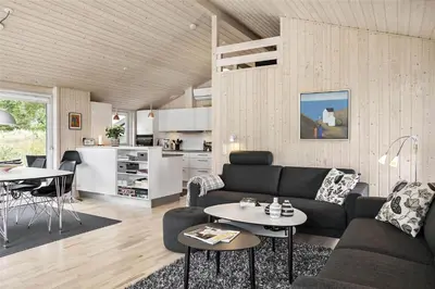 a living room with a couch and a table at BL377-Blokhus-Maxvej-9 in Blokhus
