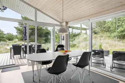 a dining room with a white table and chairs at BL377-Blokhus-Maxvej-9 in Blokhus