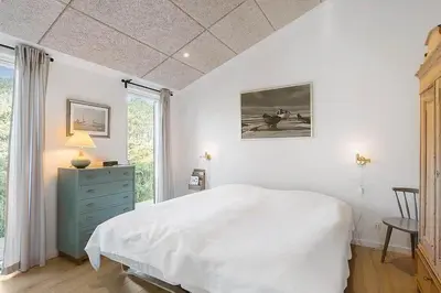 a bedroom with a white bed and a window at BL1231-Pandrup-Lunen-54 in Pandrup