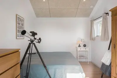 a camera on a tripod in a bedroom with a bed at BL1231-Pandrup-Lunen-54 in Pandrup