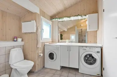 a bathroom with a washing machine and a sink at BL314-Blokhus-Bakkevaenget-5 in Blokhus