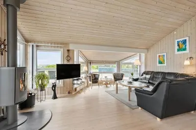 a living room with a couch and a table at BL314-Blokhus-Bakkevaenget-5 in Blokhus