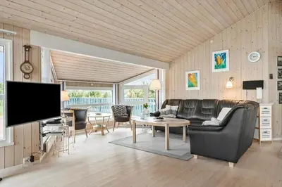 a living room with leather furniture and a flat screen tv at BL314-Blokhus-Bakkevaenget-5 in Blokhus