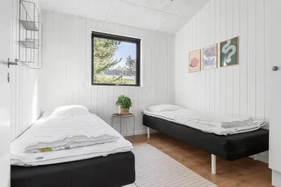 a bedroom with two beds and a window at BL1485-Blokhus-Jaegervaenget-2-A in Blokhus