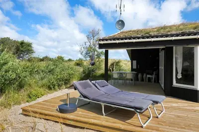 a deck with a chair on top of a house at BL450-Saltum-Graabakken-8 in Saltum