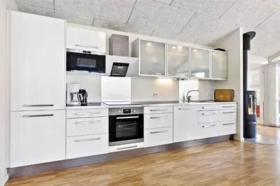 a white kitchen with white cabinets and appliances at BL1633-Saltum-Nordvestvej-18 in Saltum
