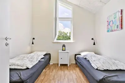 two beds in a room with a window at BL1633-Saltum-Nordvestvej-18 in Saltum