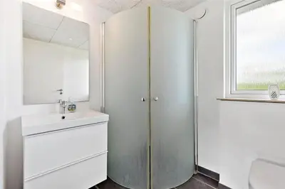 a bathroom with a shower and a sink and a mirror at BL1633-Saltum-Nordvestvej-18 in Saltum