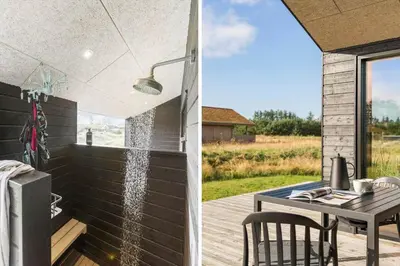 a shower on a patio with a table and a table at BL1445-Saltum-Laustvej-7 in Saltum