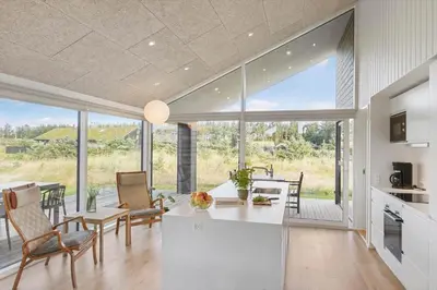 a kitchen and dining room with a large glass window at BL1445-Saltum-Laustvej-7 in Saltum