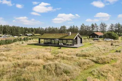 a house with a green roof in a field at BL1445-Saltum-Laustvej-7 in Saltum