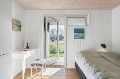 a bedroom with a bed and a desk and a window at BL1445-Saltum-Laustvej-7 in Saltum