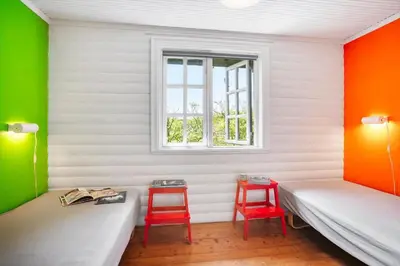 a room with two beds and two red stools at BL1459-pandrup-Gl-Jacobsvej-24 in Pandrup