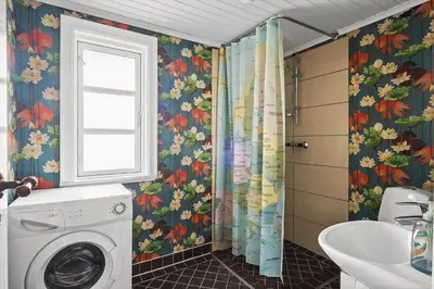 a bathroom with a washing machine and a window at BL1459-pandrup-Gl-Jacobsvej-24 in Pandrup