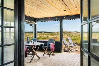 a screened porch with a table and chairs on it at BL1459-pandrup-Gl-Jacobsvej-24 in Pandrup