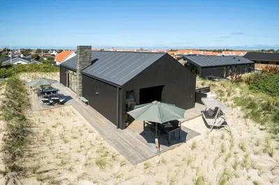 an overhead view of a black house with an umbrella at BL1433-Blokhus-Mollevej-11 in Blokhus