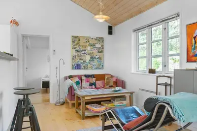 a living room with a table and chairs in it at BL1273-Blokhus-Vester-Klitvej-15 in Blokhus