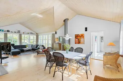 a living room with a table and chairs at BL1273-Blokhus-Vester-Klitvej-15 in Blokhus