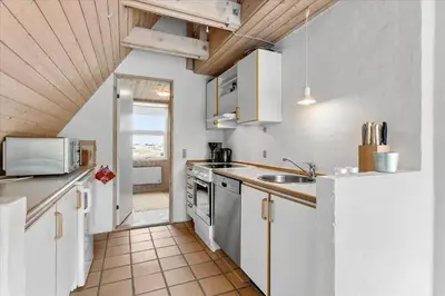 a kitchen with a sink and a refrigerator at BL1738-Pandrup-Narhvalen-11 in Pandrup