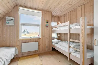 a room with two bunk beds and a window at BL1738-Pandrup-Narhvalen-11 in Pandrup