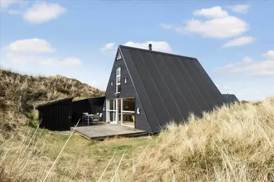 a black house sitting on top of a hill at BL1738-Pandrup-Narhvalen-11 in Pandrup