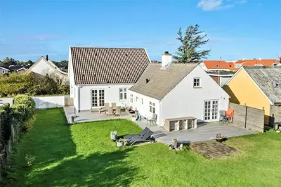 an aerial view of a white house with a yard at BL327-Blokhus-Sonder-I-By-23 in Blokhus