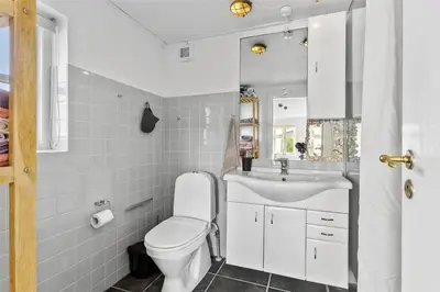 a white bathroom with a toilet and a sink at BL327-Blokhus-Sonder-I-By-23 in Blokhus