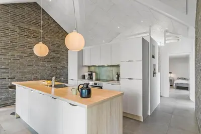 a kitchen with white cabinets and a counter top at BL1468-Blokhus-Moreavej-59-B in Blokhus