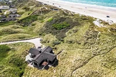 an aerial view of a house on a hill next to the beach at BL1468-Blokhus-Moreavej-59-B in Blokhus
