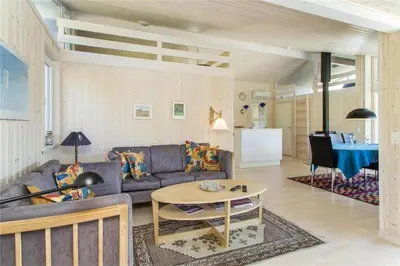 a living room with a couch and a table at BL289-Blokhus-Moreavej-41 in Blokhus