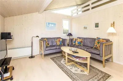 a living room with a couch and a table at BL289-Blokhus-Moreavej-41 in Blokhus