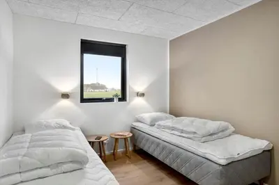 two beds in a white room with a window at BL1479-Saltum-Solmarken-1 in Saltum