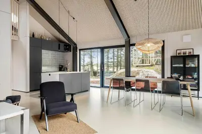a kitchen and dining room with a table and chairs at BL1327-Blokhus-Braendevinsstien-5 in Blokhus