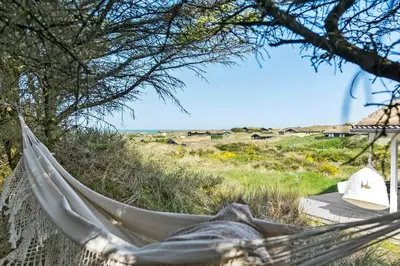 a hammock in a field with a view of the ocean at BL1428-Saltum-Karen-Mariesvej-31-D in Saltum
