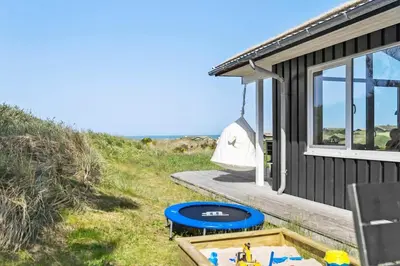 a small house with a pool next to a beach at BL1428-Saltum-Karen-Mariesvej-31-D in Saltum