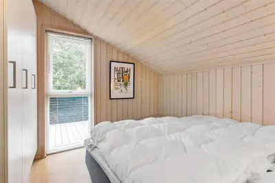 a large white bed in a room with a window at BL757-Saltum-Tolhoj-12 in Saltum