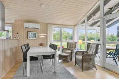 a dining room with a white table and chairs at BL757-Saltum-Tolhoj-12 in Saltum