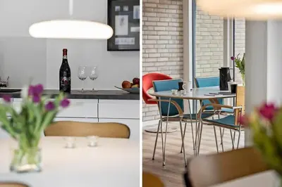 two pictures of a kitchen and a table with a bottle of wine at BL1359-Blokhus-Bellevueparken-24 in Blokhus