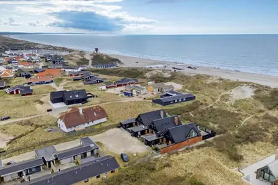 an aerial view of a village next to the beach at BL1359-Blokhus-Bellevueparken-24 in Blokhus