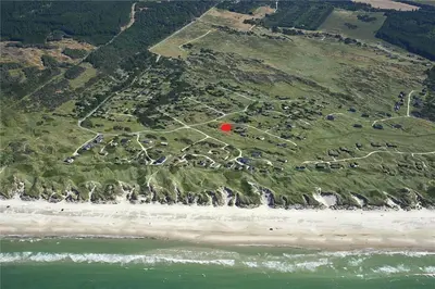 an aerial view of a beach with a red island at BL1497-Pandrup-Hunetorp-Klitvej-271 in Pandrup