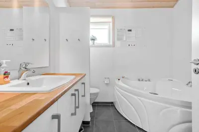 a bathroom with a tub and a sink and a toilet at BL497-Saltum-Tolhoj-4 in Saltum